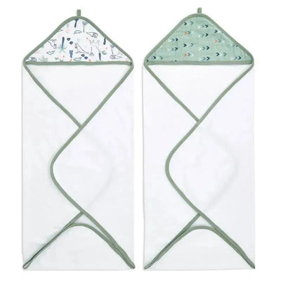 Hooded towels featuring a dinosaur print and an arrow pattern, designed for infants, in soft cotton muslin fabric.