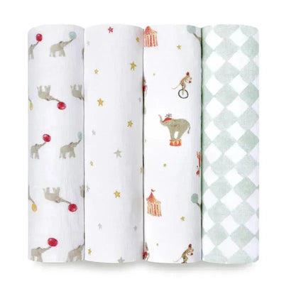 Four Aden + Anais swaddle blankets featuring elephant and circus designs with colorful patterns and soft textures.