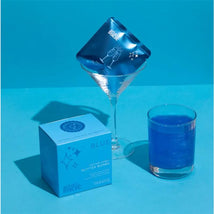 Blue cotton candy drink glitter bombs being added to a blue drink, with decorative balloons and packaging nearby.