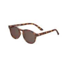 Babiators baby sunglasses in a tortoiseshell pattern with dark lenses and logo on the arm.