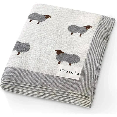 100% luxury cotton baby blanket featuring a sheep pattern in ivory and gray, labeled Bleu La-La.