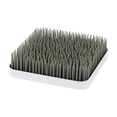 Boon GRASS countertop drying rack in grey with a square base and numerous upright flexible pegs for drying dishes.