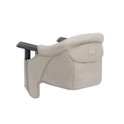 Inglesina Fast Table Chair in cream color featuring a cushioned back, detachable fabric, and side pocket for storage.