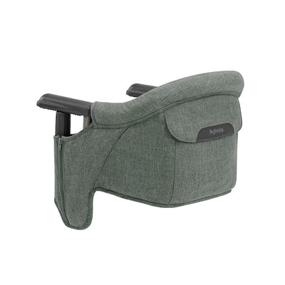 Inglesina Fast Table Chair in Pine Green Melange, featuring a soft fabric exterior and sturdy attachment arms for secure placement.