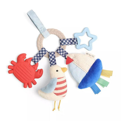 Teething activity toy featuring a braided ring, a red crab, a striped bird, and a blue star-shaped toy.