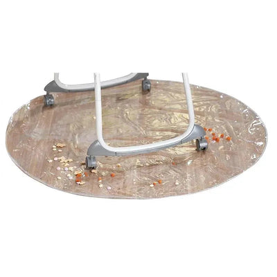 Jeep Mealtime & Playtime Mat under a high chair with scattered food, featuring a round, easy-to-clean surface.