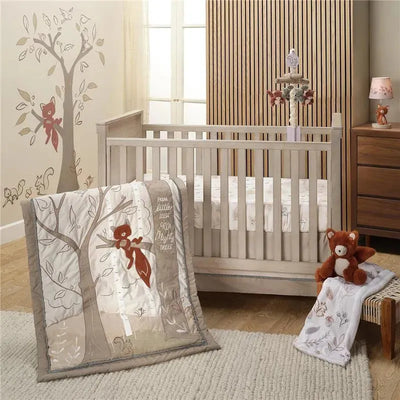 3-piece bedding set featuring a quilt with a fox and trees design, paired with a stuffed fox near a crib.