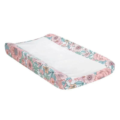 Changing pad cover featuring a floral design with pink and blue flowers, designed for infant use.