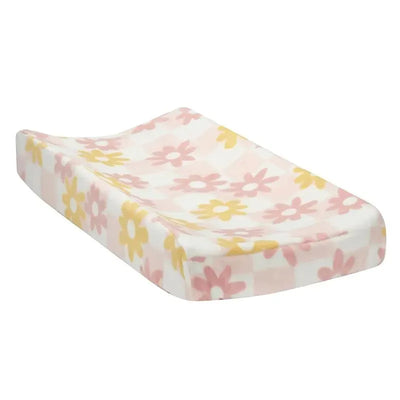 Changing pad cover featuring a pastel floral design with pink and yellow flowers on a white background.