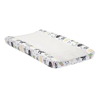 Changing pad cover featuring Star Wars characters, with a soft white surface and patterned edges depicting various characters.