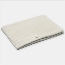 Martin Aranda blanket in sweater knit cotton blend, Amieva Sage, shown folded with a decorative button and lace trim.