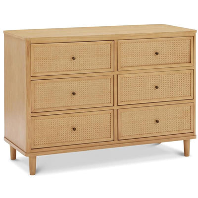 Honey-colored six-drawer dresser featuring cane panel details and round knobs. Ideal for storage.