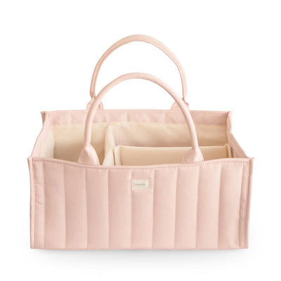 Mushie Baby Diaper Caddy in blush, featuring quilted exterior and two handles for organizing newborn essentials.
