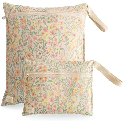 Mushie water-resistant wet bags in pastel blooms design, featuring two sizes with floral patterns and zippers.