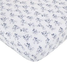 Crib bedding set featuring a white fabric with repeated blue sketch-style Mickey Mouse illustrations.