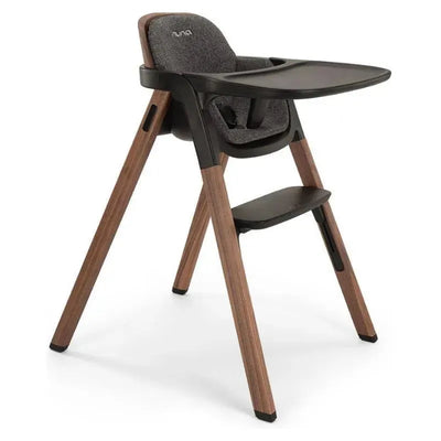 Nuna BRYN High Chair in Sanderson, featuring a modern design with wooden legs and a comfortable, padded seat.
