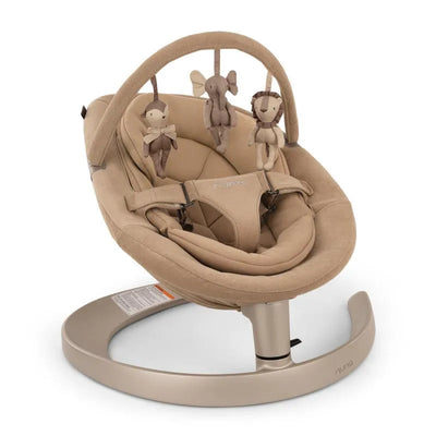 Tan Nuna LEAF™ grow Baby Seat & Rocker featuring plush fabric and three hanging toys: a monkey, elephant, and lion.