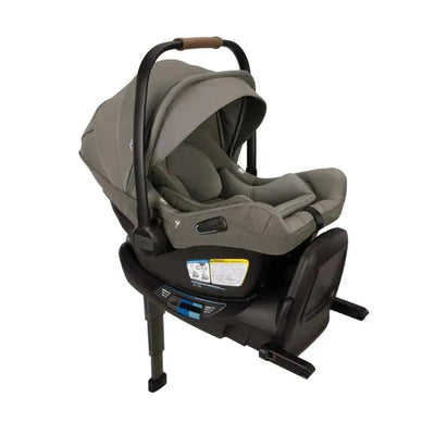 Nuna PIPA™ aire rx Infant Car Seat in Granite with a padded seat, adjustable canopy, and user instructions visible on the base.
