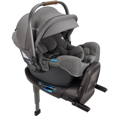 Nuna PIPA™ rx infant car seat in granite, featuring a reclining handle and adjustable harness, mounted on a RELX base.