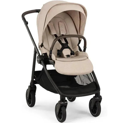 Nuna SWIV™ Stroller in Biscotti color, featuring a soft fabric seat, adjustable canopy, and two front wheels for easy maneuverability.