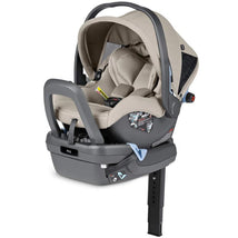 Peg-Perego Primo Viaggio Nido Infant Car Seat in Astral, featuring a beige fabric cover, adjustable handle, and safety labels.