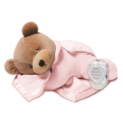 Pink plush bear sleeping with a soft blanket, featuring a sound machine for soothing sounds.