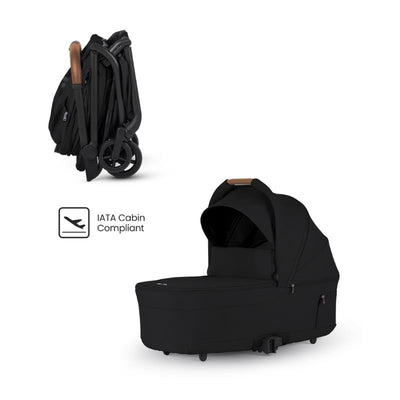 Compact folding bassinet in Onyx Black with a sleek design, featuring a handle and IATA cabin compliance icon.