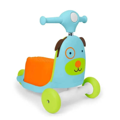 Skip Hop Zoo 3-In-1 Ride-On Toy in the shape of a dog, featuring a blue body, orange seat, and green wheels.