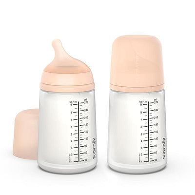 Suavinex 2-pack anti-colic baby bottles, each 9 oz with medium flow nipple, featuring clear measurements and fair tone caps.