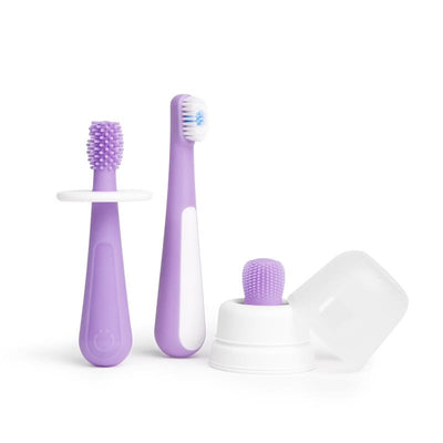 Toothbrush training set for babies and toddlers, includes purple handles, a training brush, and a silicone finger brush.