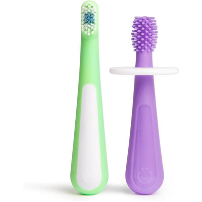 Green and white child-sized toothbrush with a textured purple training brush, designed for babies and toddlers.