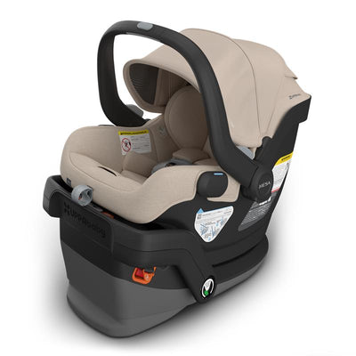 Uppababy Mesa V3 infant car seat in Oat Mélange color with safety labels, adjustable handle, and base features.