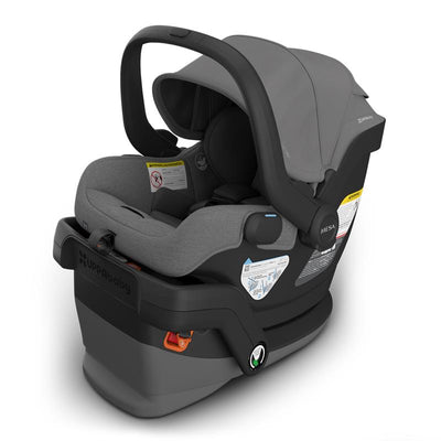 Uppababy Mesa V3 infant car seat in charcoal mélange, featuring a grey fabric seat, safety labels, and a supportive canopy.