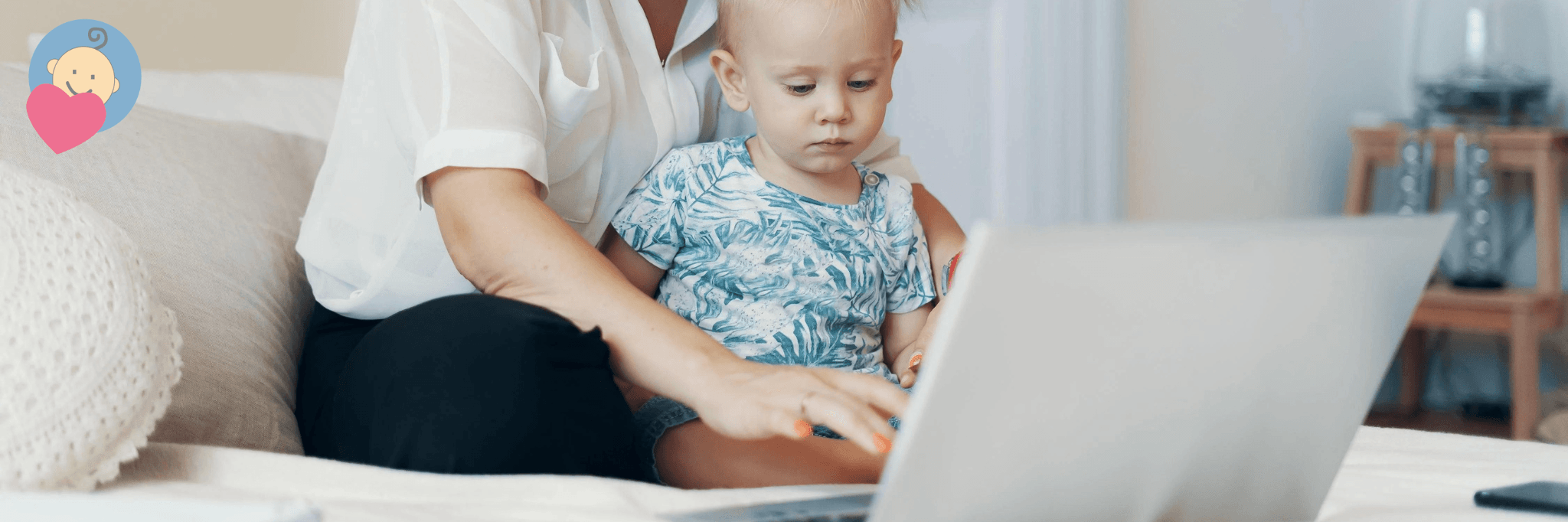 Mom and baby using laptop together on couch, shopping for baby gear online