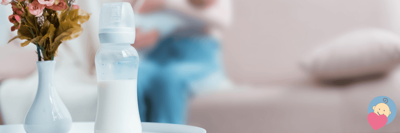 Baby bottle with milk beside vase of flowers, cozy nursery setting
