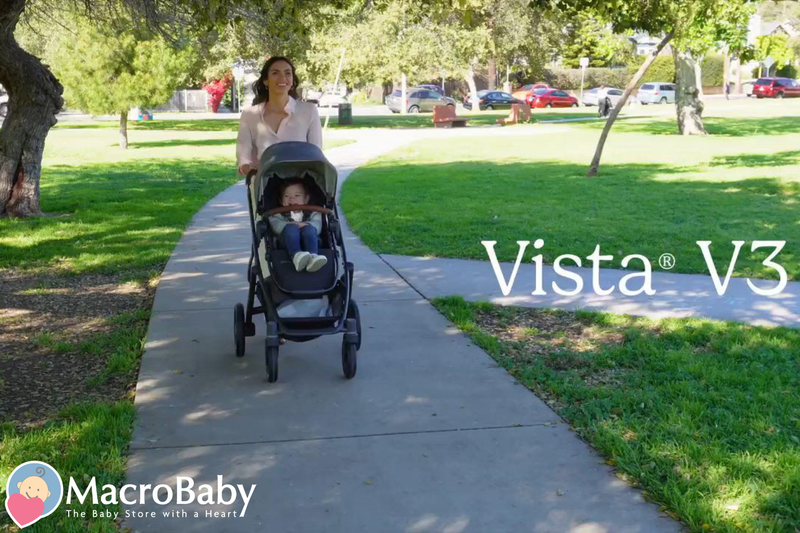 Mom pushing baby in Vista V3 stroller on park path, ideal for outdoor walks and comfort.