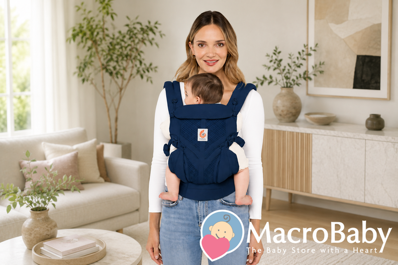 Mom carrying baby in navy ergonomic baby carrier, perfect for newborns and infants, ideal for hands-free parenting.