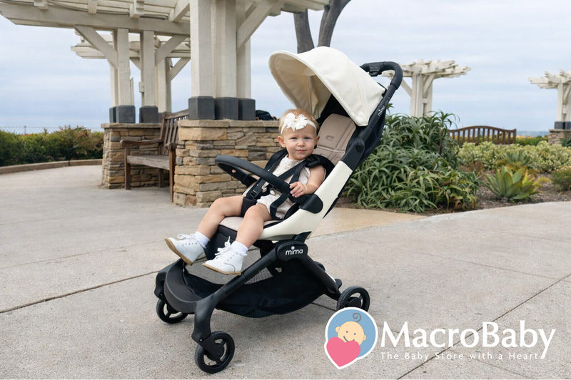 Baby in Mima stroller at outdoor park, perfect for strolls with comfort and style.