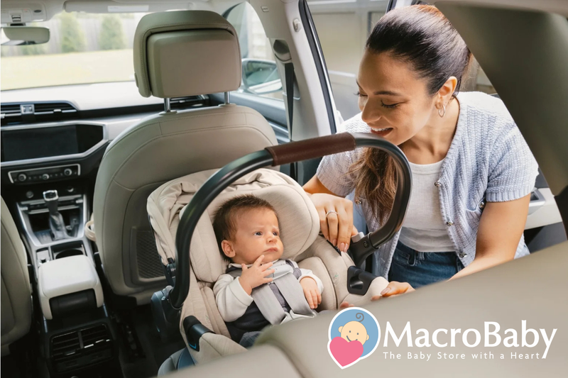 Mom securing baby in car seat inside vehicle, safe infant travel gear