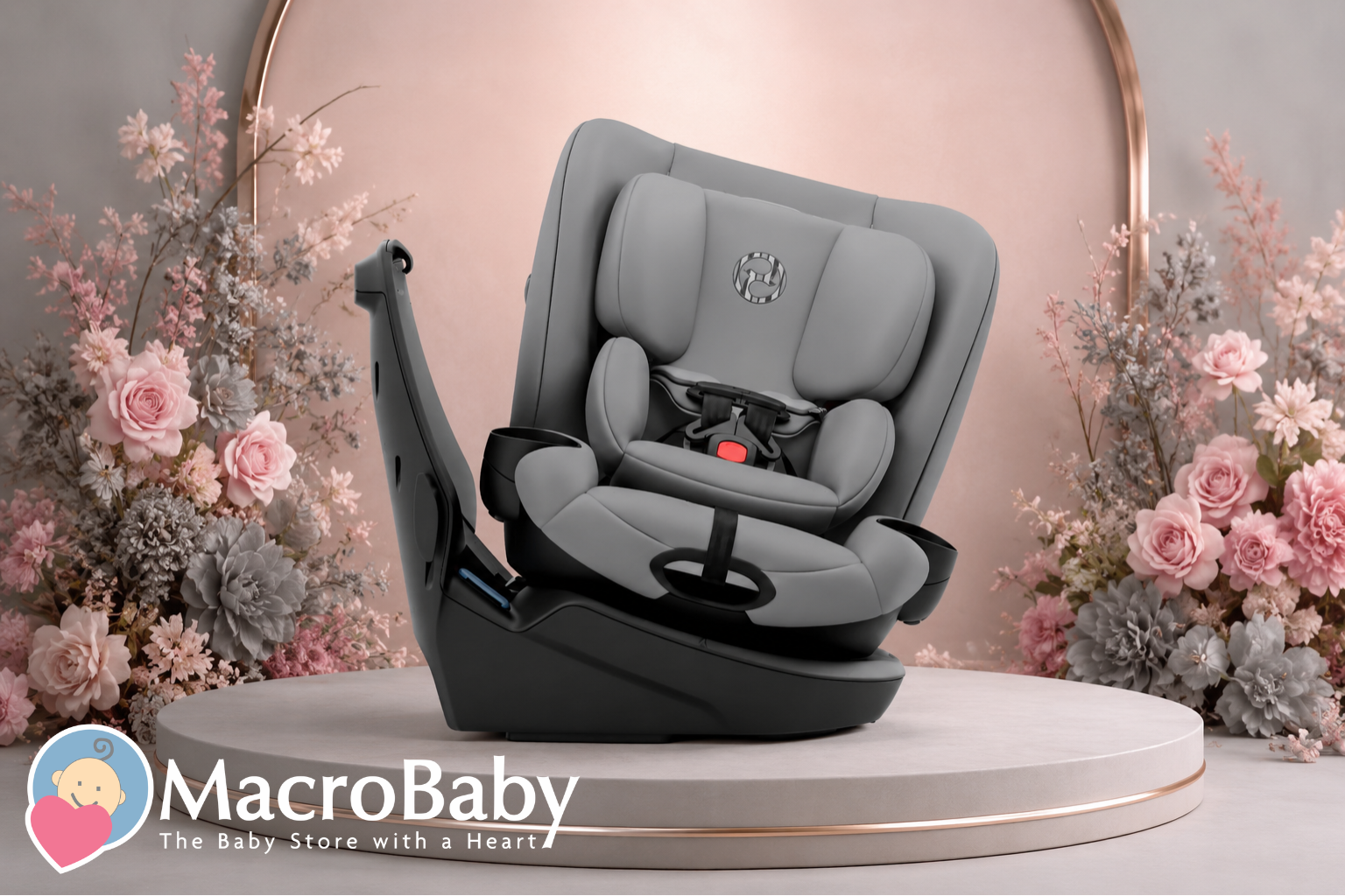 Gray convertible baby car seat with cup holders, displayed on pedestal with floral decor