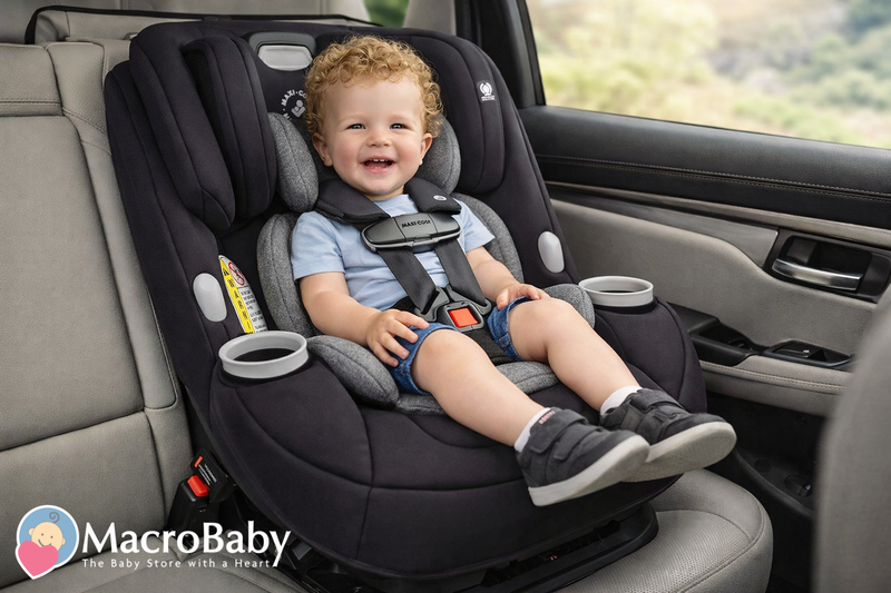 Happy toddler in black Maxi-Cosi car seat with cup holders, safely buckled in vehicle