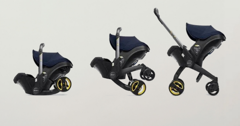 Convertible baby stroller with car seat, navy canopy, and yellow-accent wheels for easy travel