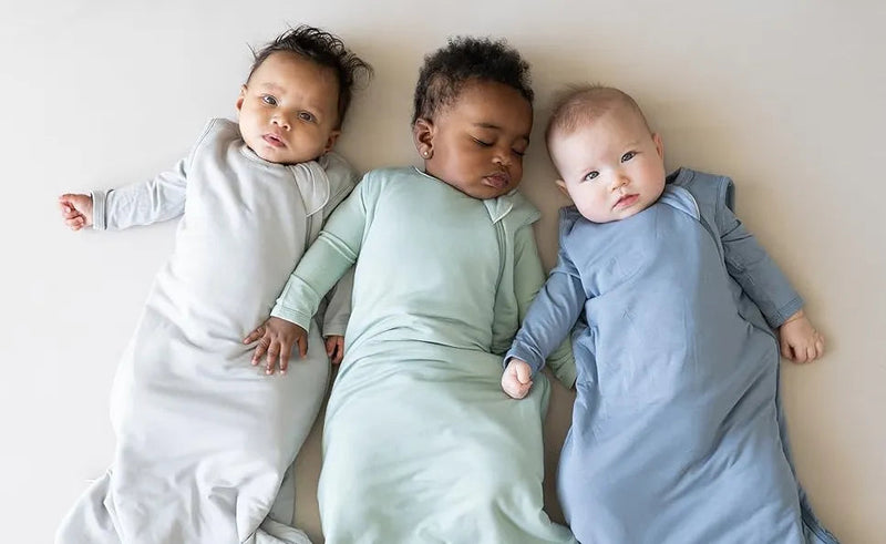 Three babies in soft sleep sacks, cozy baby bedding for safe sleep