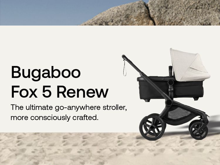 Bugaboo Fox 5 Renew stroller with beige canopy, black frame, and all-terrain wheels on sandy terrain