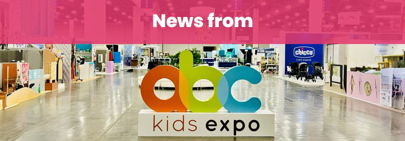 ABC Kids Expo trade show floor with colorful logo, baby gear displays, and Chicco booth visible