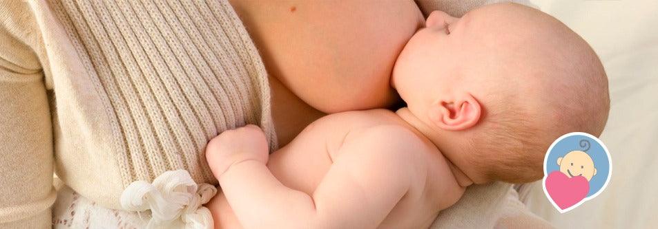 Mother breastfeeding newborn baby, cozy knit sweater, gentle parenting moment