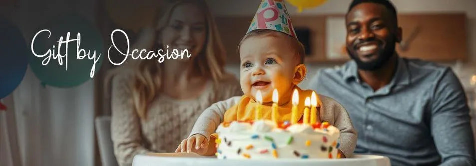 Baby's first birthday cake with candles, happy parents celebrating, gift by occasion
