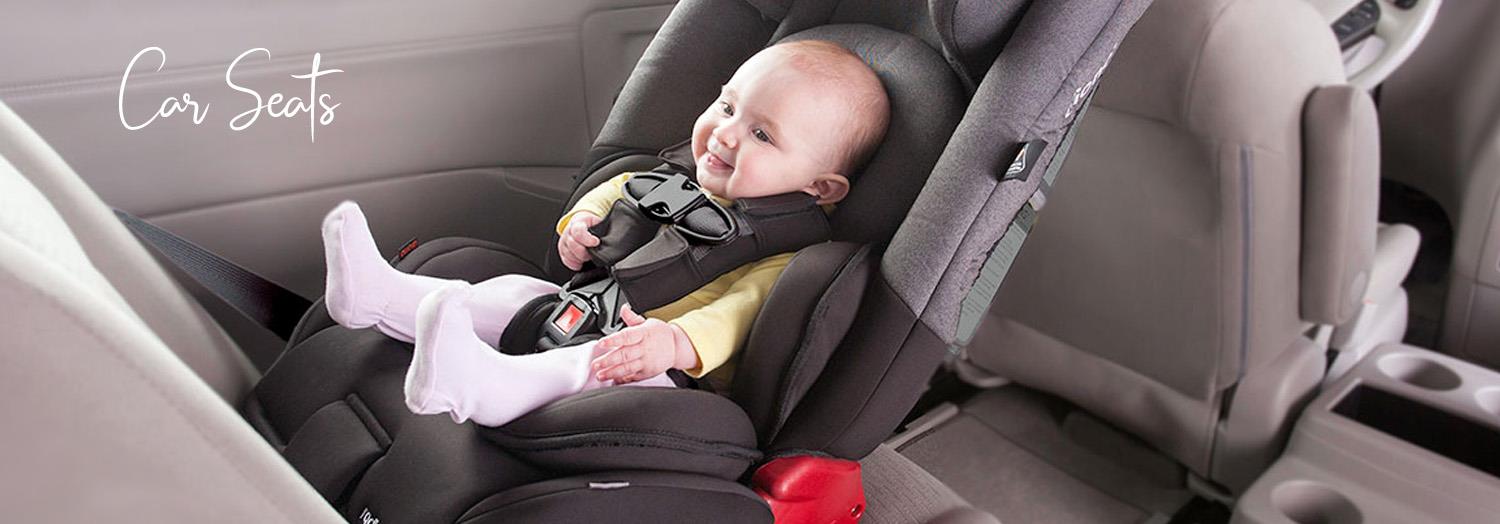 Happy baby in black infant car seat, safely buckled inside vehicle, ideal for parents seeking secure baby travel gear