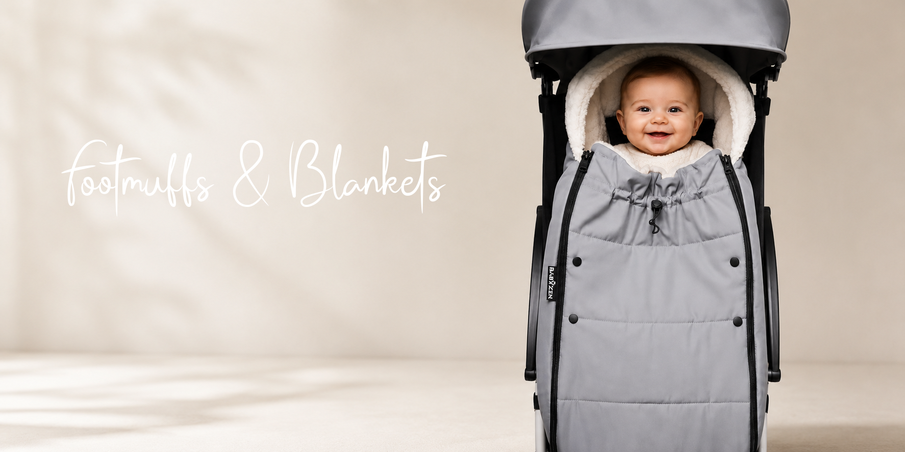 Baby in gray stroller footmuff with cozy hood, perfect for winter strolls and baby comfort