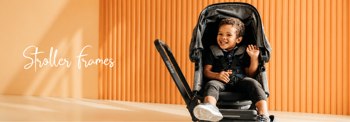 Happy baby in a stroller frame, smiling and waving against warm orange background
